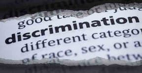 Torn paper revealing the dictionary word discrimination