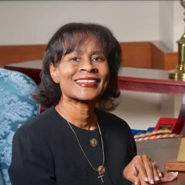 Founder Velveta Golightly-Howell smiling at her desk