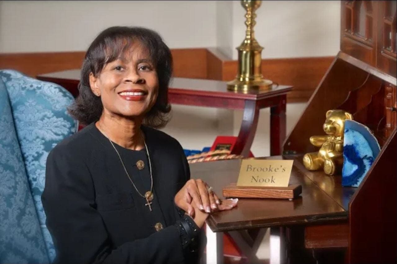 Founder Velveta Golightly-Howell smiling at her desk